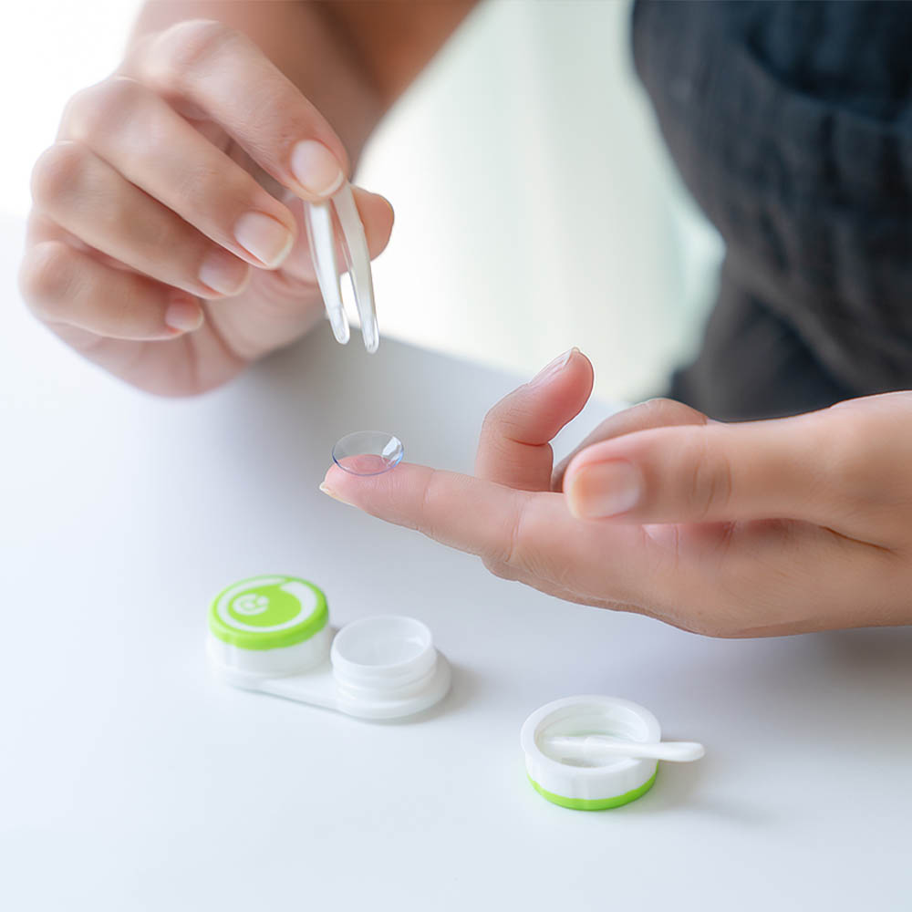 woman inserting contact lenses