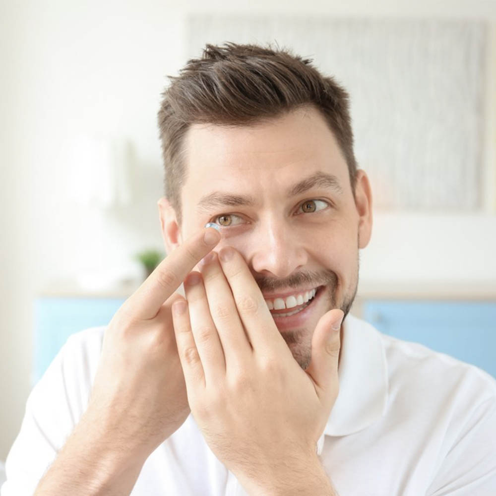 man putting in contact lens