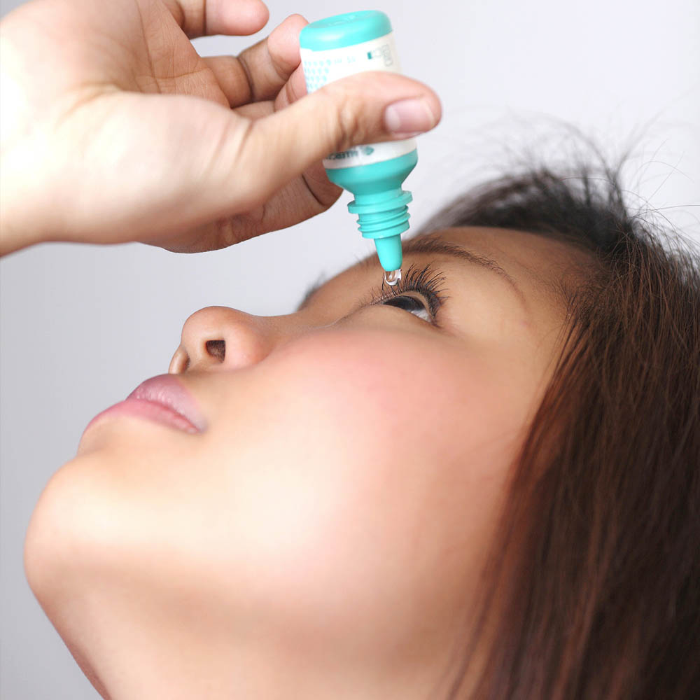girl with eye drops after lasik