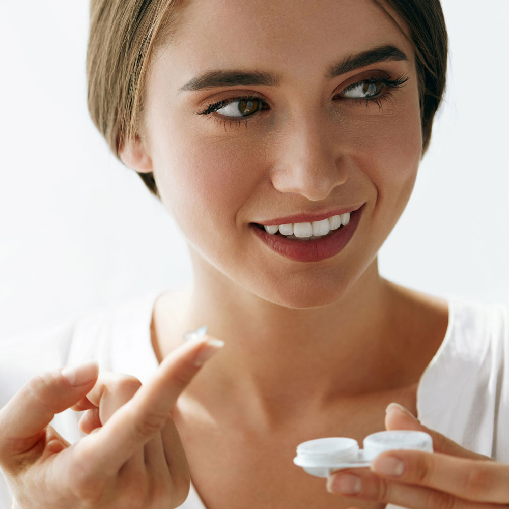 Woman inserterting scleral lenses